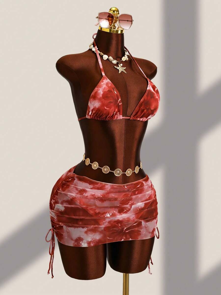 Women's black 3-piece bikini set featuring a halter triangle top with removable padding, high-waisted bottoms, and a knee-length mesh skirt with tie details.