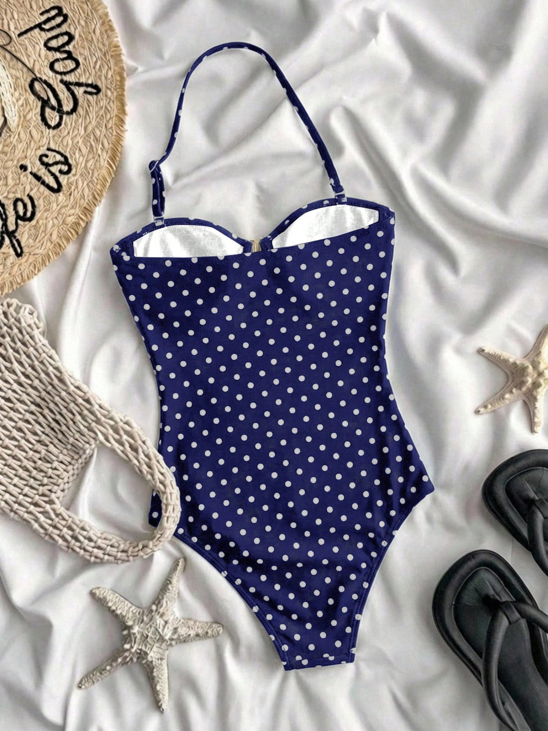 Tween girls' blue polka dot one-piece swimsuit with spaghetti strap halter neckline, high-cut bottom, and metal starfish decor for beach vacation wear.