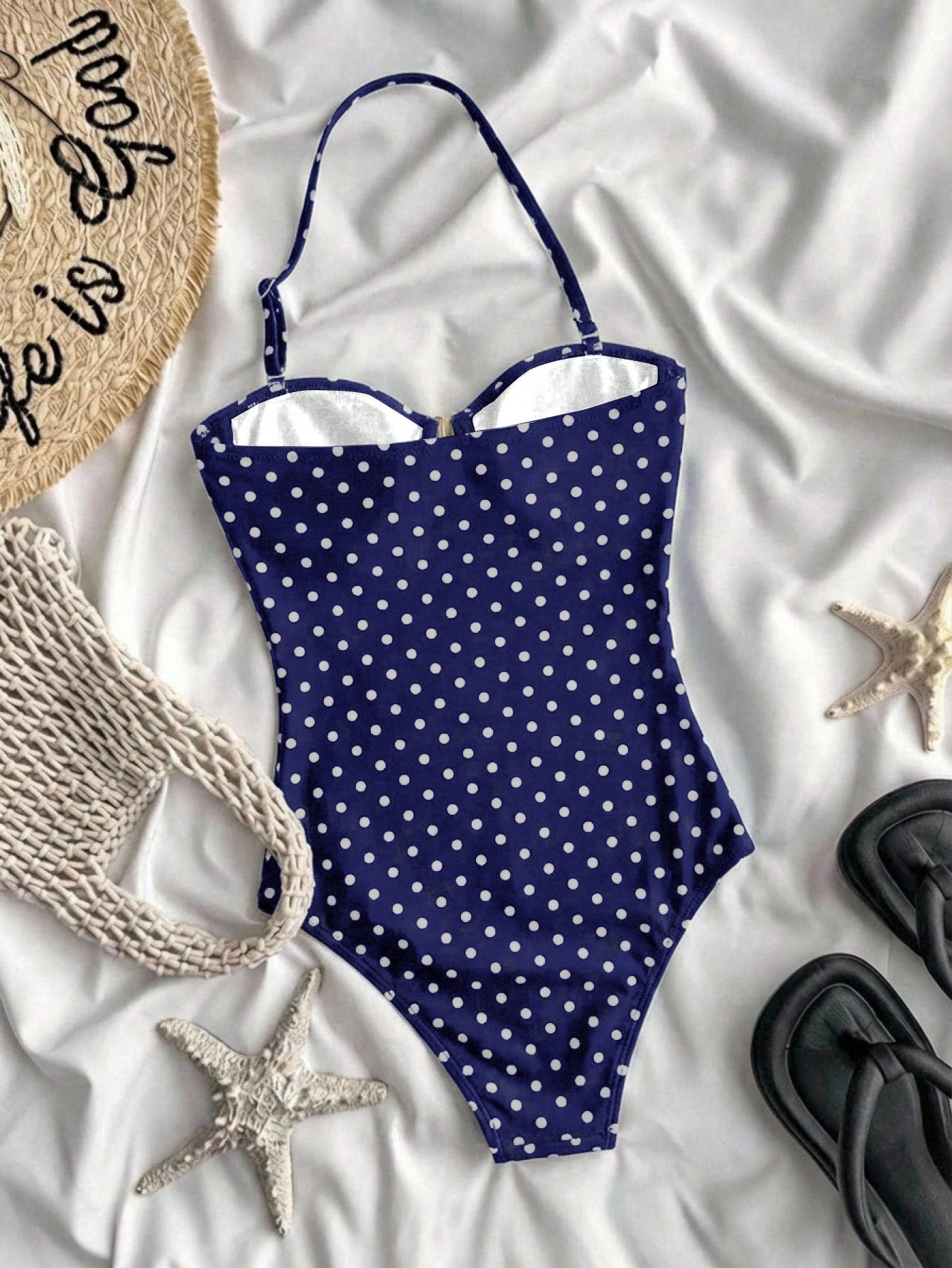 Tween girls' blue polka dot one-piece swimsuit with spaghetti strap halter neckline, high-cut bottom, and metal starfish decor for beach vacation wear.