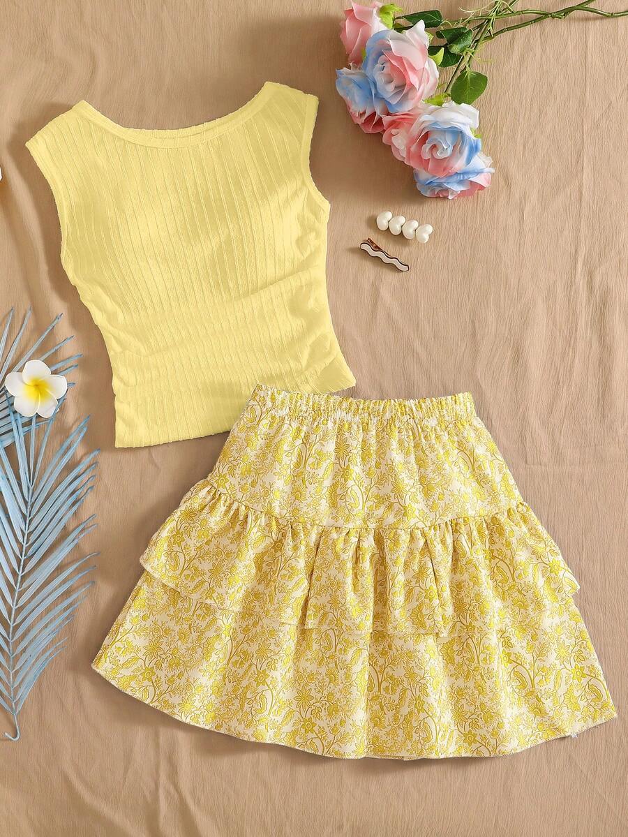Light blue two-piece outfit set for tween girls with a sleeveless round neck vest top and a tiered ruffle cake skirt featuring a plant pattern.