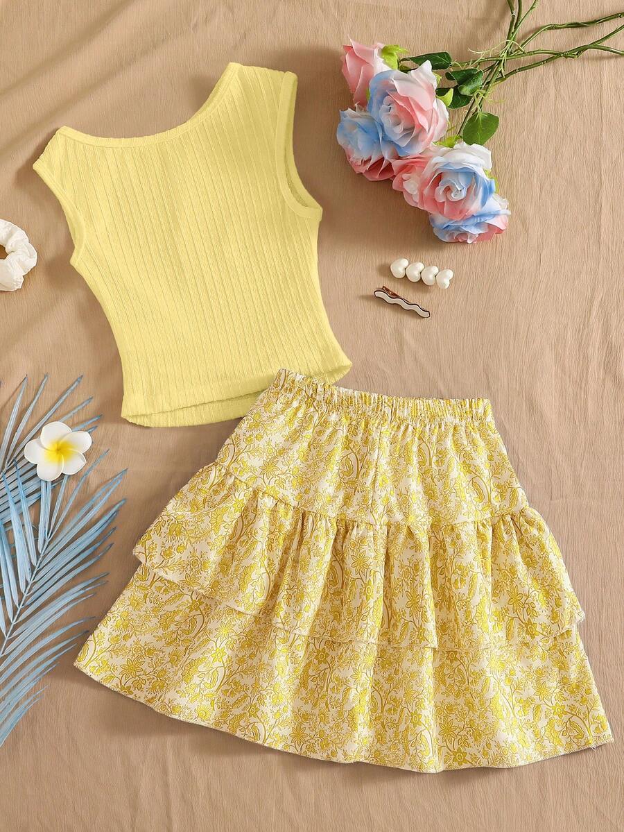 Light blue two-piece outfit set for tween girls with a sleeveless round neck vest top and a tiered ruffle cake skirt featuring a plant pattern.