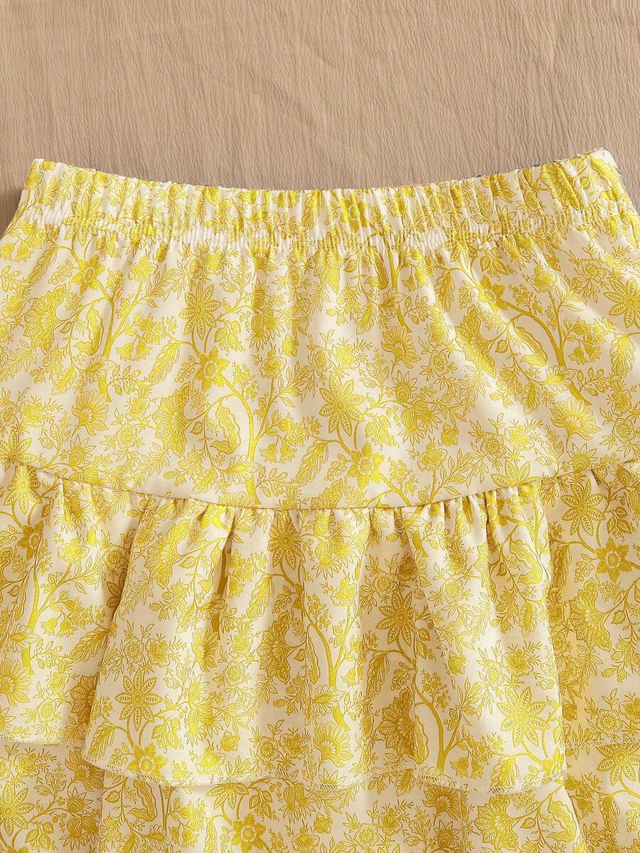 Light blue two-piece outfit set for tween girls with a sleeveless round neck vest top and a tiered ruffle cake skirt featuring a plant pattern.