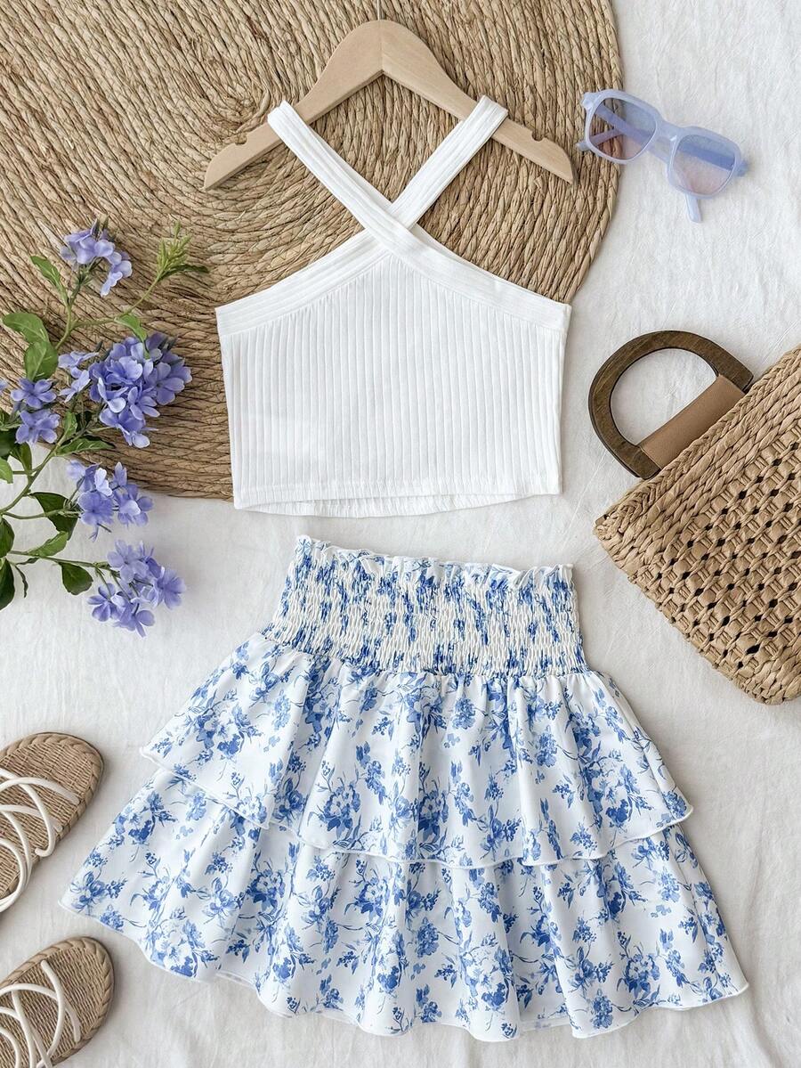 Tween girls blue and white 2-piece set with a striped halter neck vest top and a floral high-waist tiered paperbag skirt.