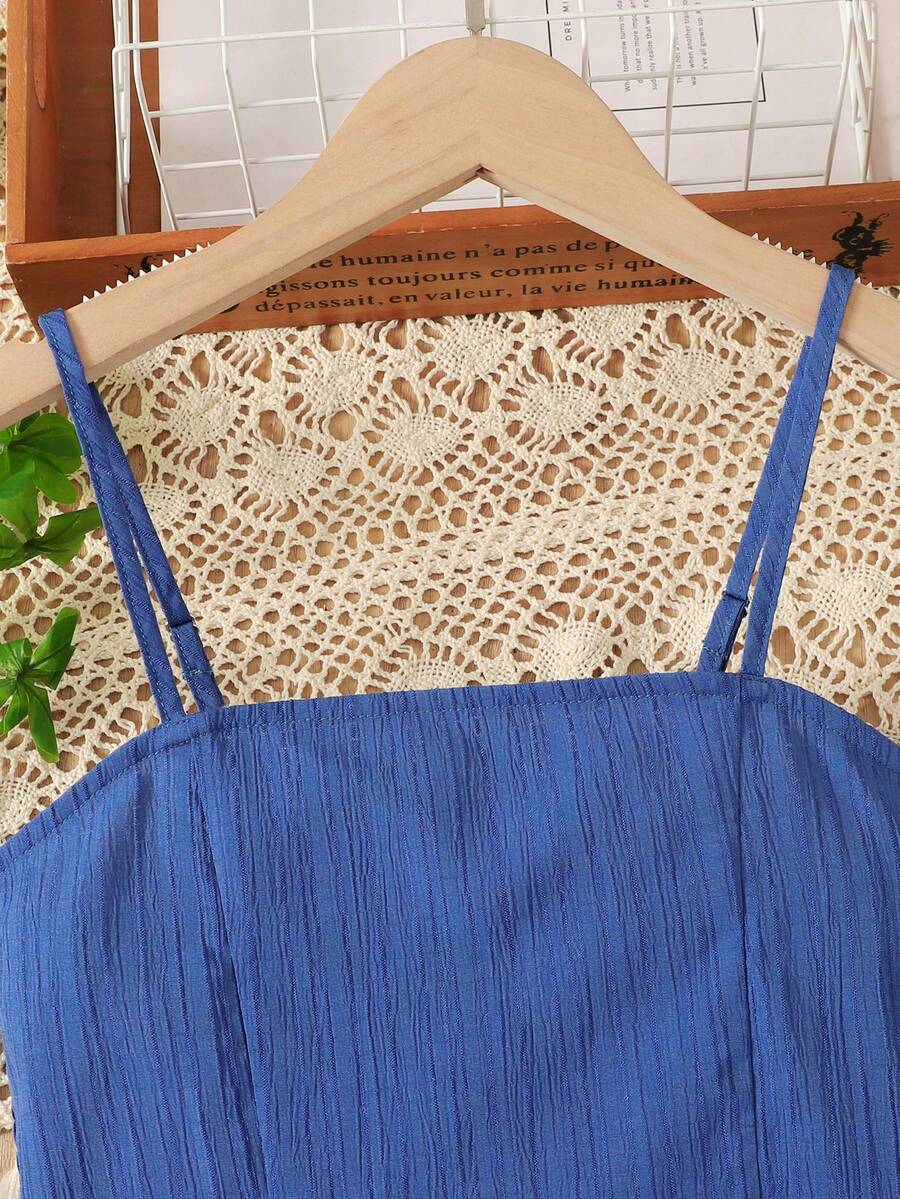 Tween girl wearing a black sleeveless spaghetti strap camisole top with 3D bow decor and matching leopard print wide leg long pants.