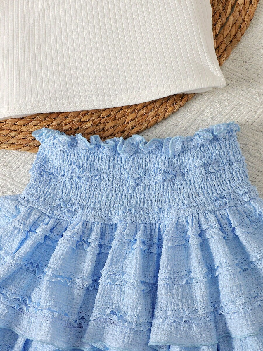 Tween girls blue and white 2-piece set with a striped halter neck vest top and a floral high-waist tiered paperbag skirt.
