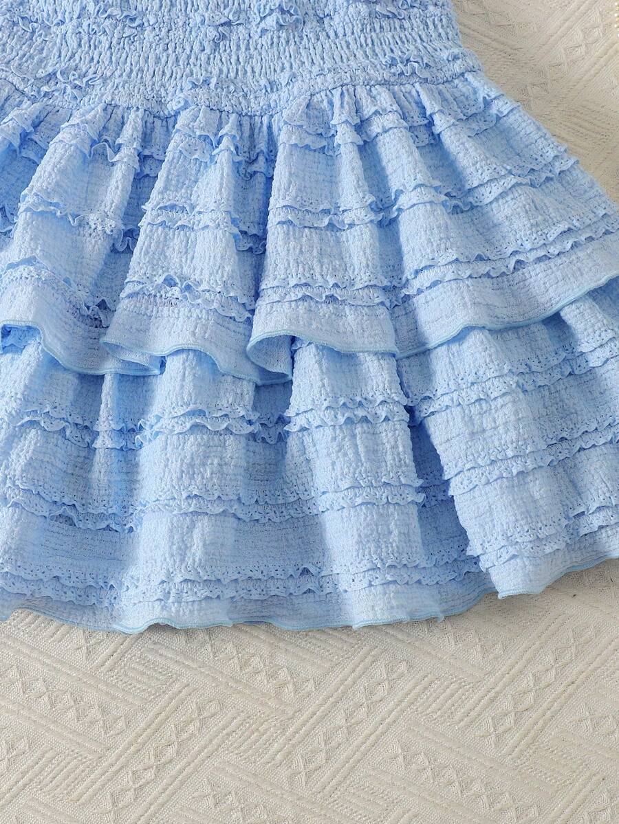 Tween girls blue and white 2-piece set with a striped halter neck vest top and a floral high-waist tiered paperbag skirt.