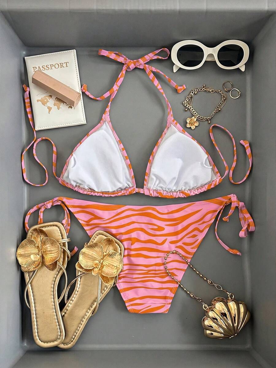 Women's black and white zebra print two-piece bikini set featuring a high waist tie-side bottom and a backless halter top with removable padding.