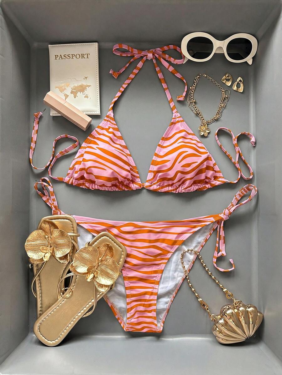 Women's black and white zebra print two-piece bikini set featuring a high waist tie-side bottom and a backless halter top with removable padding.