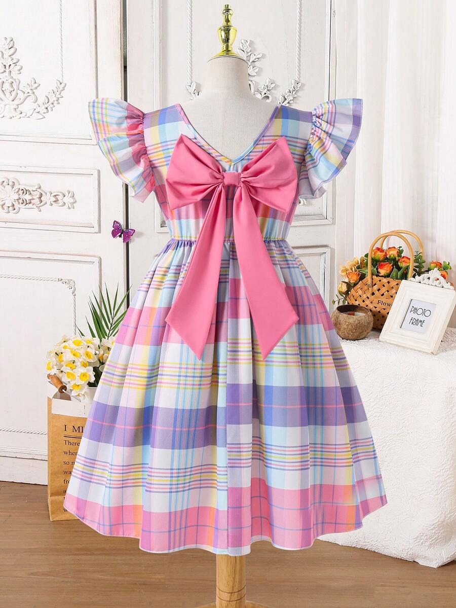 Tween girls blue short smock dress featuring flounce short sleeves, high waist flared hem, round neck, and front bow detail.