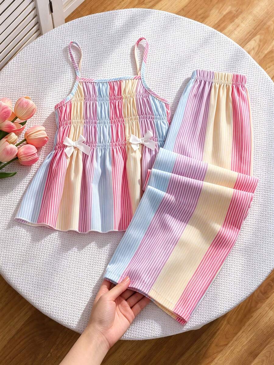 Girls 2-piece summer outfit set featuring a blue bow print camisole top with spaghetti straps and matching high-waisted straight leg pants.