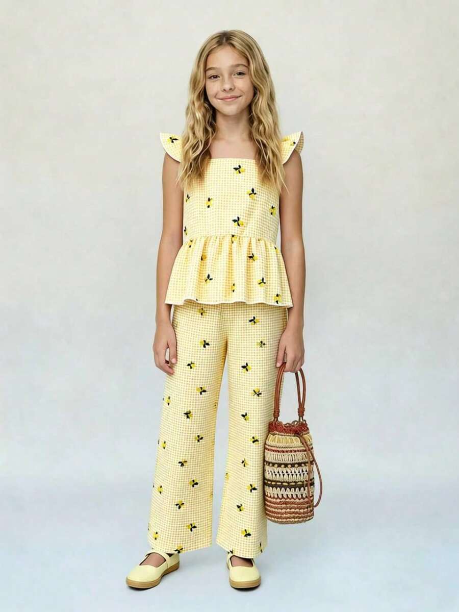 Tween girl wearing an apricot 2-piece outfit set featuring a shirred spaghetti strap short cami top and matching wide-leg long pants.