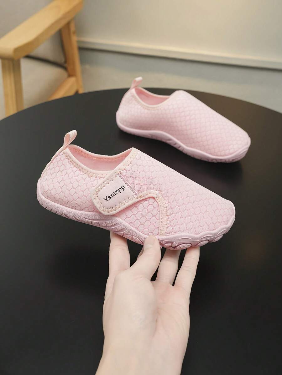 Kids breathable mesh water shoes with hook and loop closure and durable rubber outsole.