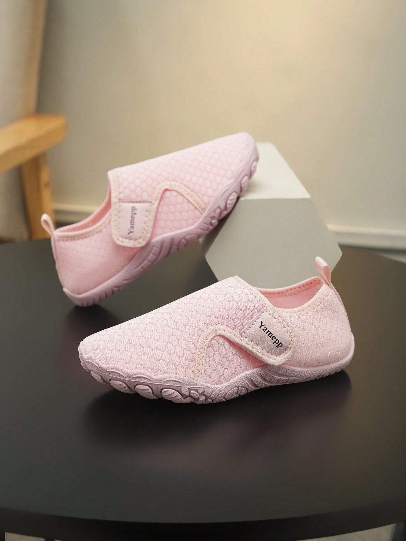 Kids breathable mesh water shoes with hook and loop closure and durable rubber outsole.