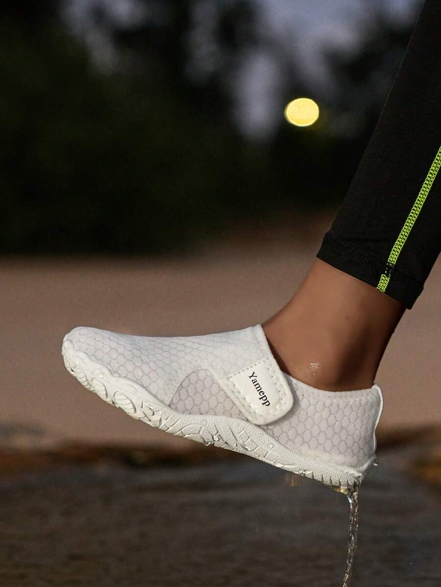Kids breathable mesh water shoes with hook and loop closure and durable rubber outsole.