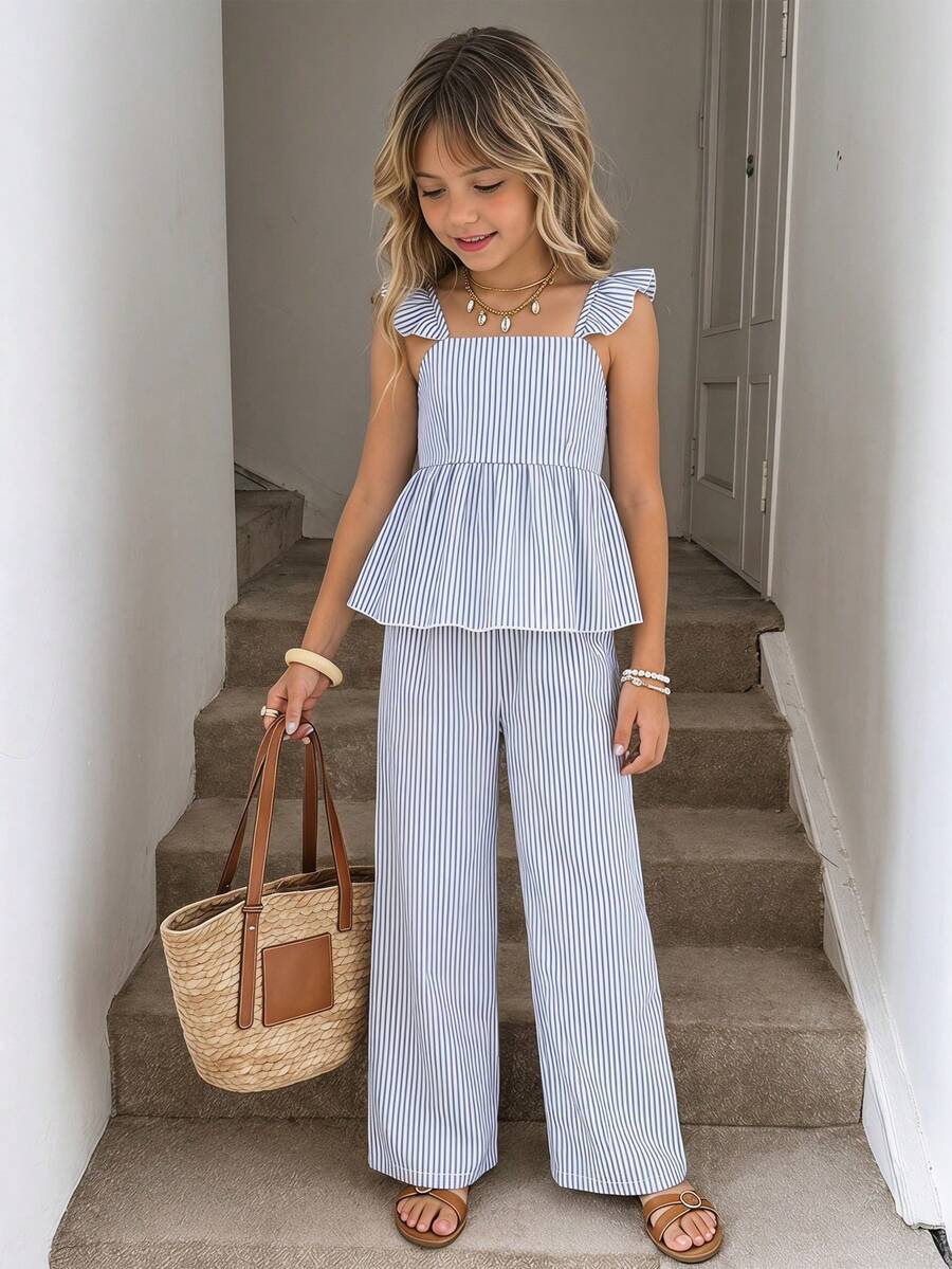Tween girl wearing an apricot 2-piece outfit set featuring a shirred spaghetti strap short cami top and matching wide-leg long pants.