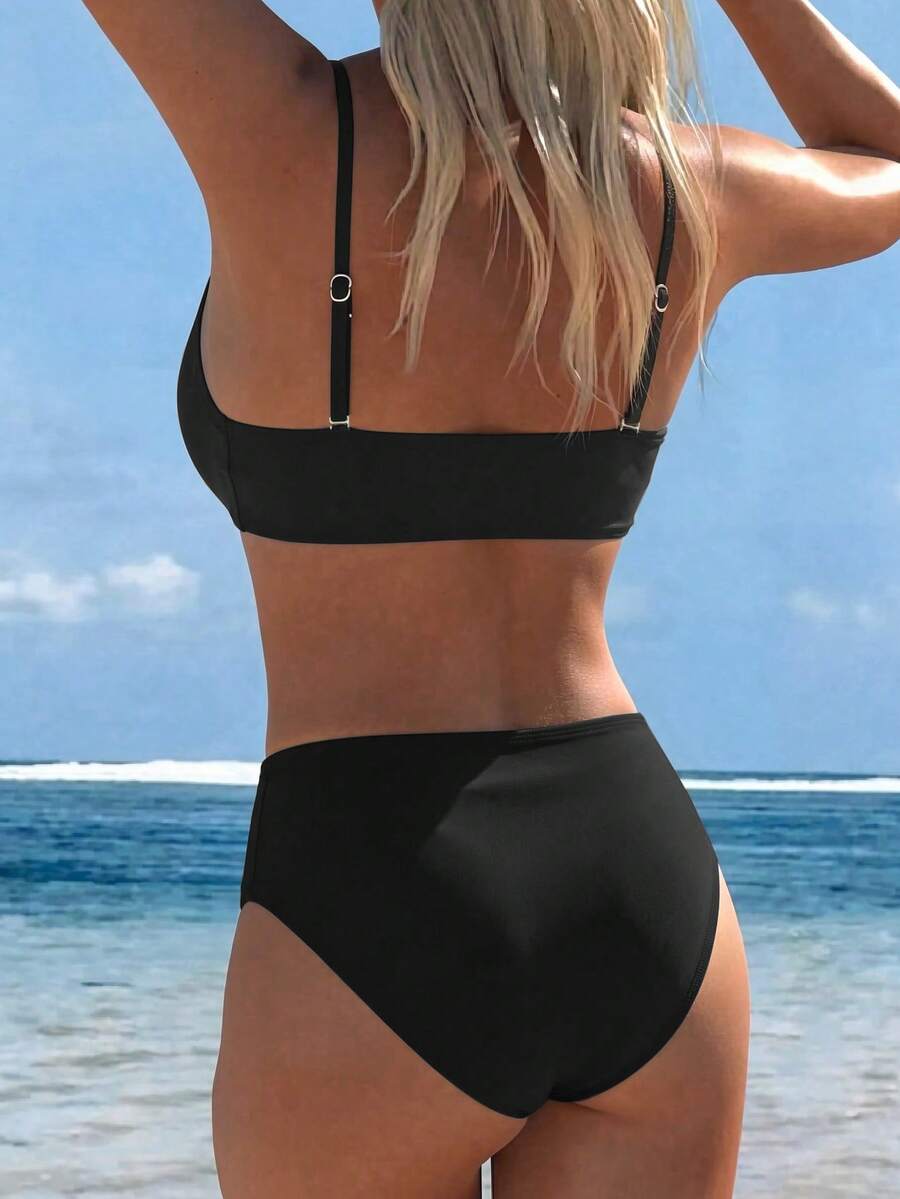 Women's black two-piece bandeau bikini set featuring high waist bottoms, backless buckle closure, and removable padding.