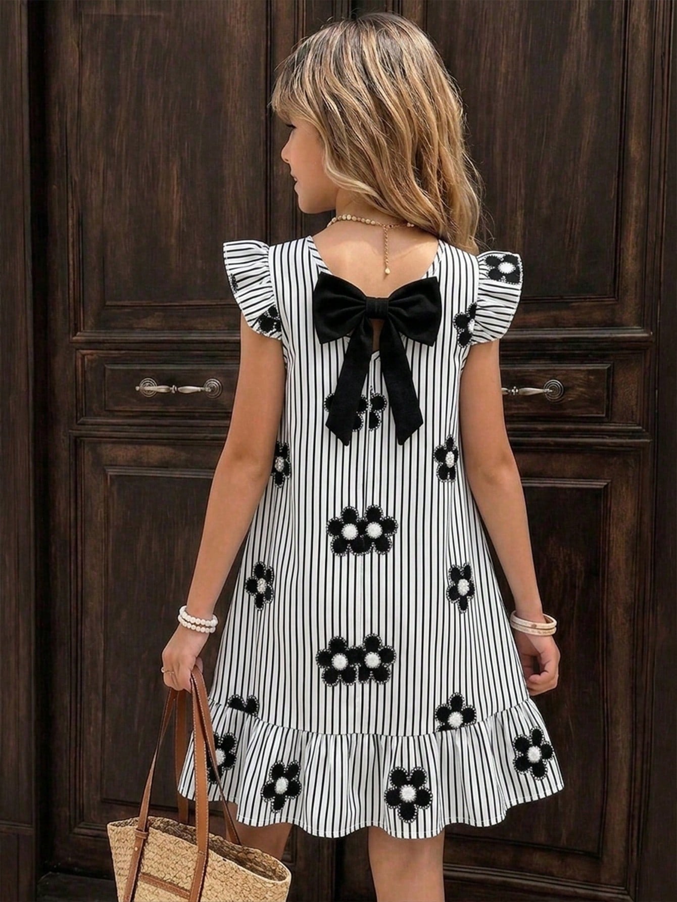 Tween girls apricot vacation midi dress featuring a round neck, cut out details, ruffle flounce accents, and geometric pattern.