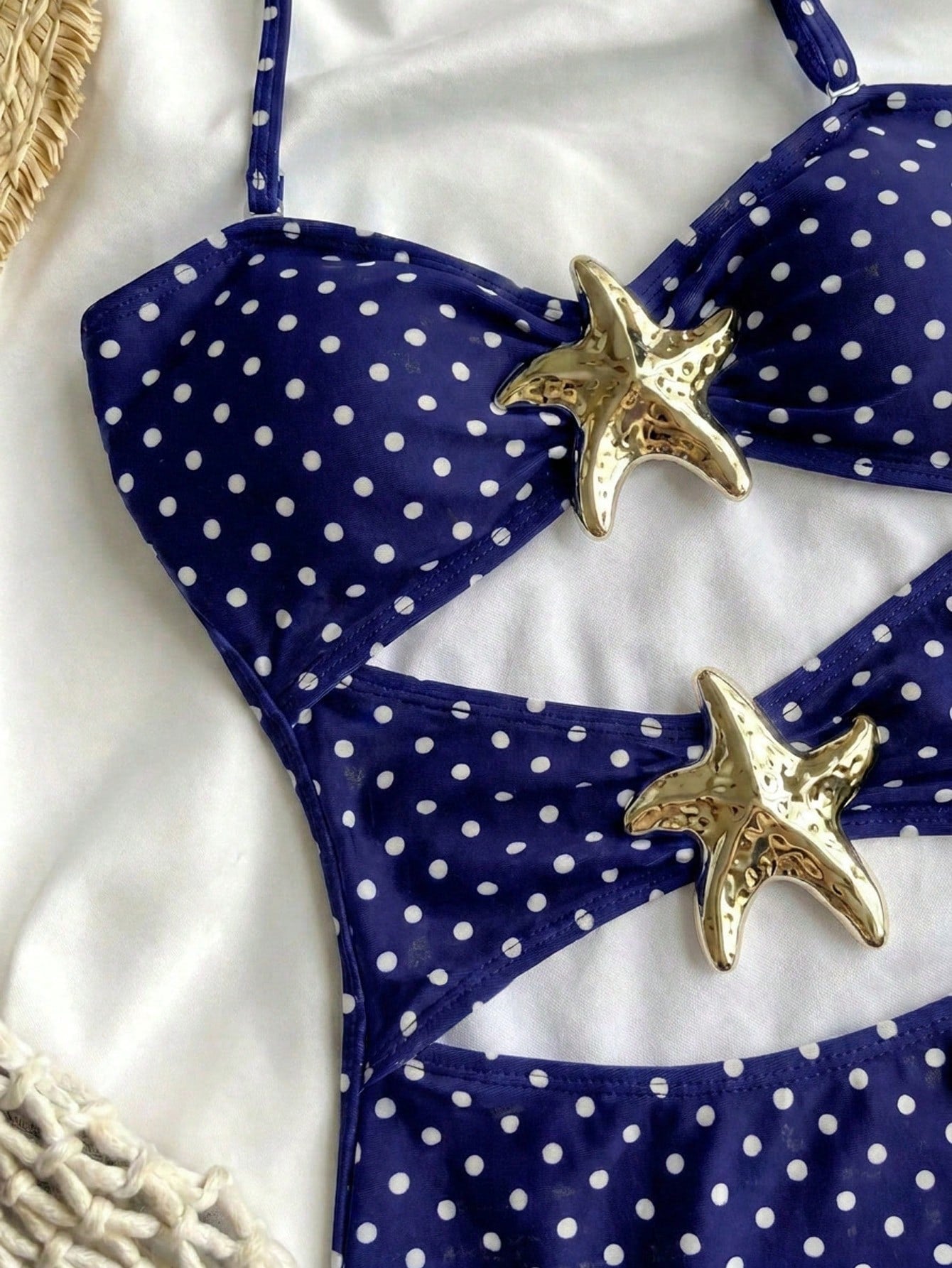Tween girls' blue polka dot one-piece swimsuit with spaghetti strap halter neckline, high-cut bottom, and metal starfish decor for beach vacation wear.