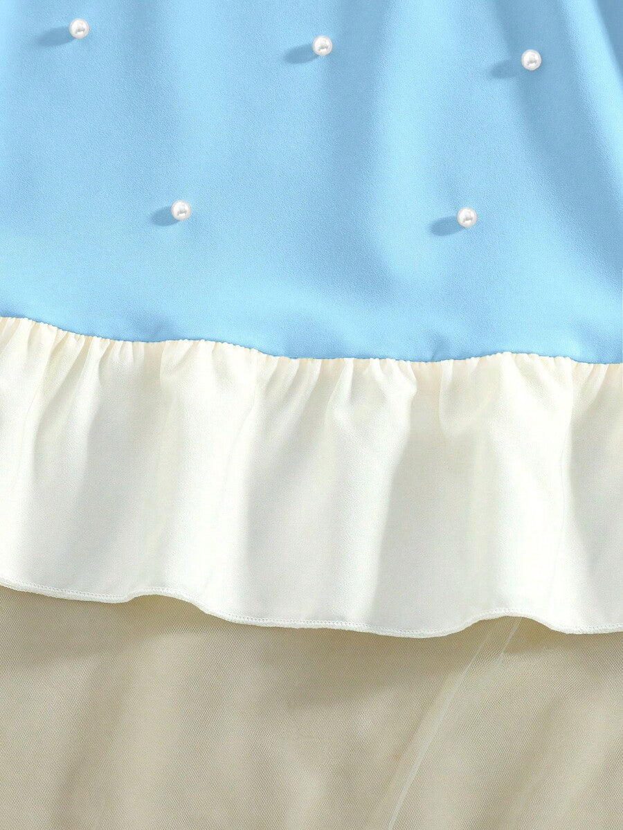 Yellow sleeveless colorblock dress for girls featuring a round neck, ruffle hem, and front bow detail.