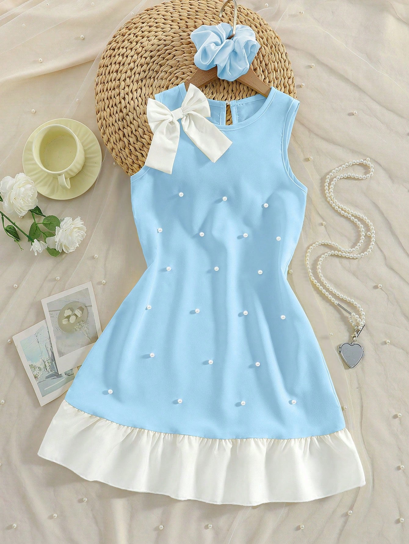 Yellow sleeveless colorblock dress for girls featuring a round neck, ruffle hem, and front bow detail.