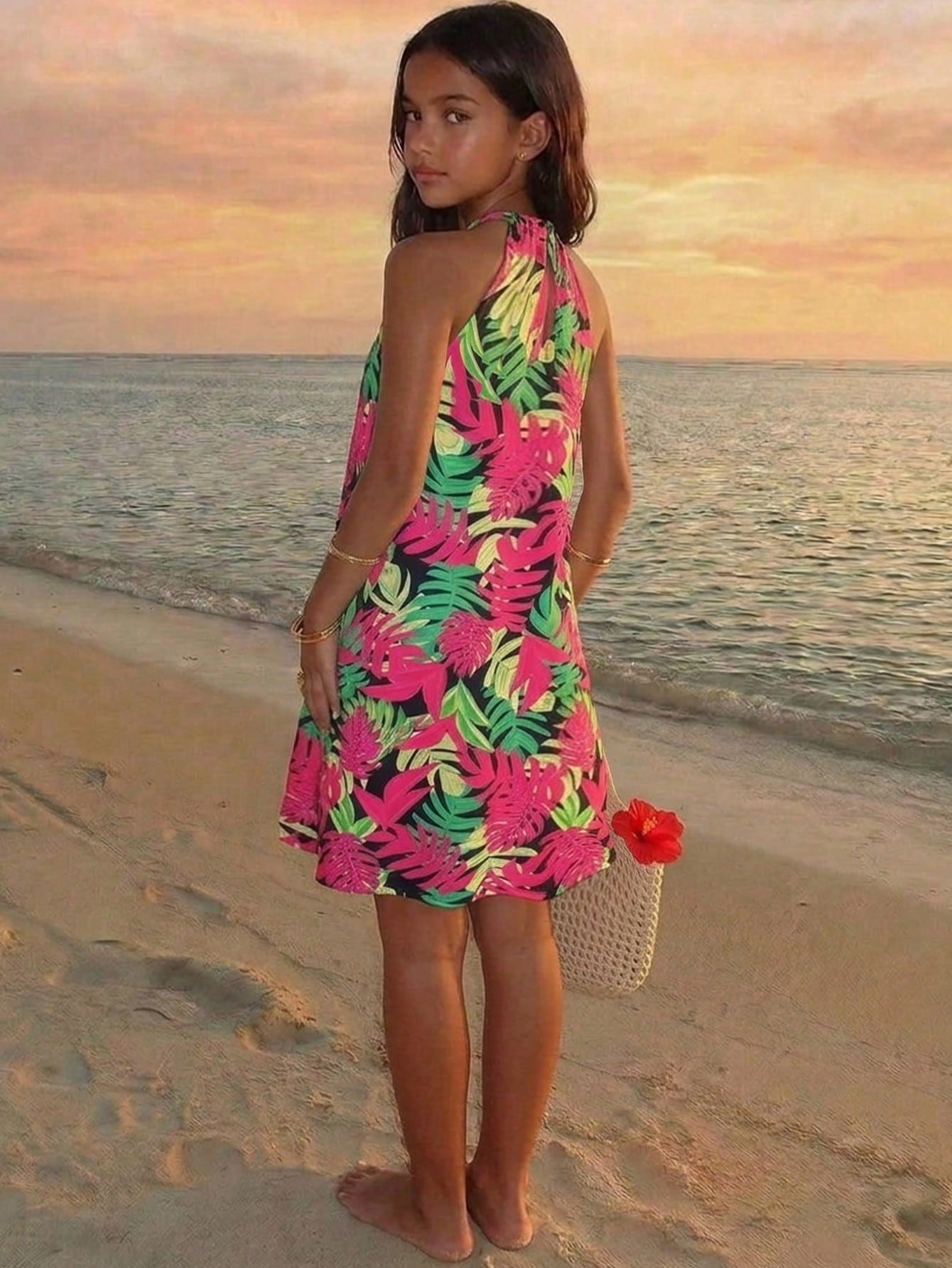 Tween girls floral print dress with halter neckline, sleeveless cold shoulder design, A-line shape, and vacation style.