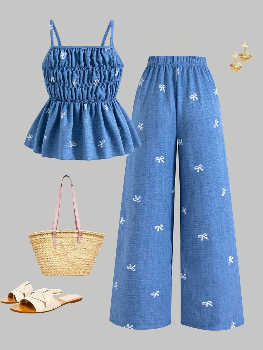 Girls 2-piece summer outfit set featuring a blue bow print camisole top with spaghetti straps and matching high-waisted straight leg pants.