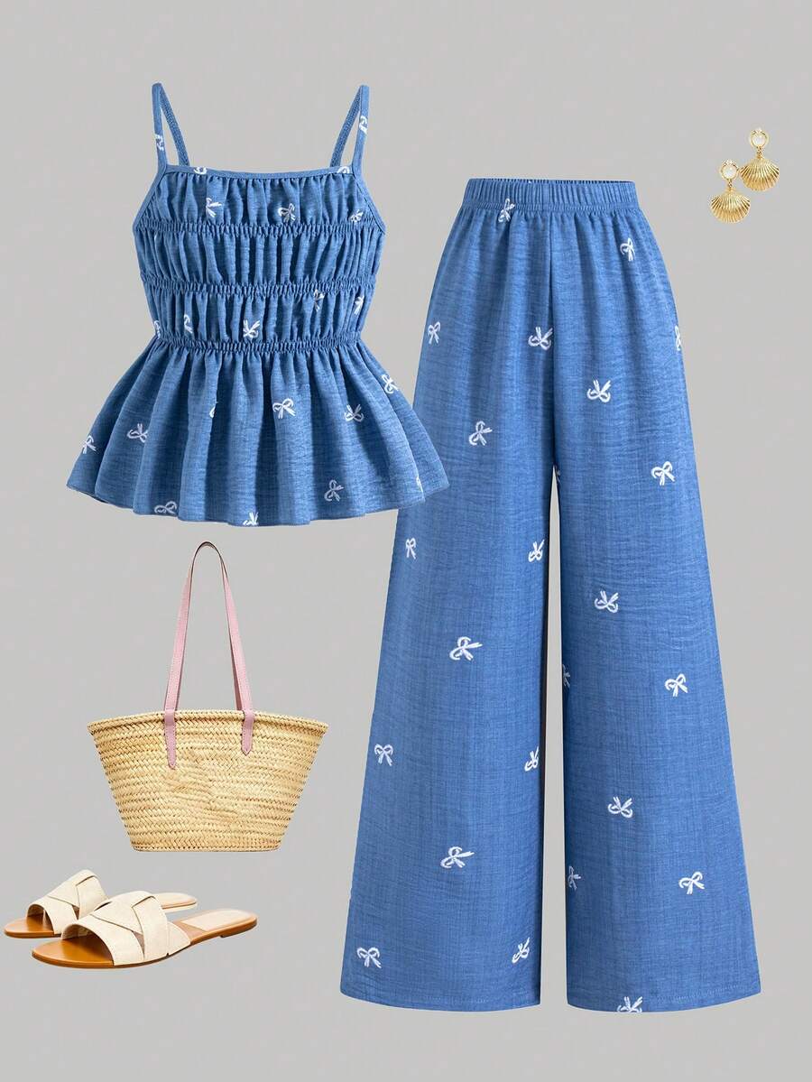 Girls 2-piece summer outfit set featuring a blue bow print camisole top with spaghetti straps and matching high-waisted straight leg pants.