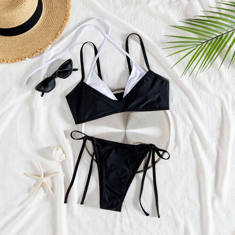 Women's color-block two-piece bikini set featuring a boho geometric pattern, tie-back halter top with removable padding, and matching tie-side bikini bottoms.