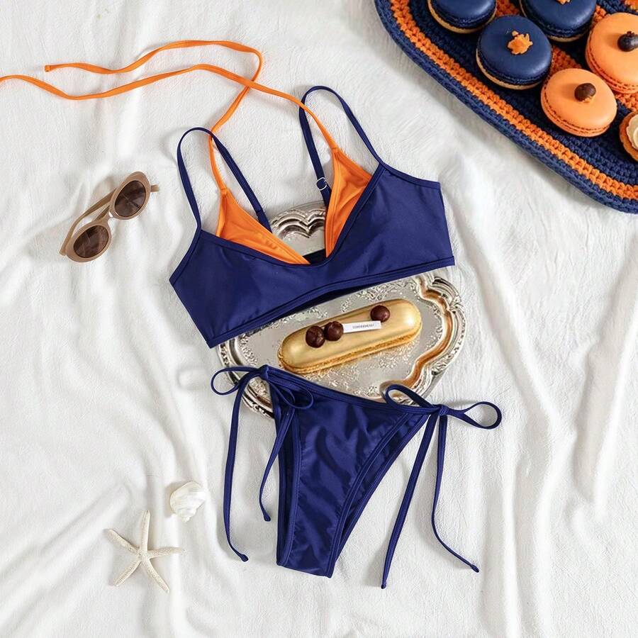 Women's color-block two-piece bikini set featuring a boho geometric pattern, tie-back halter top with removable padding, and matching tie-side bikini bottoms.