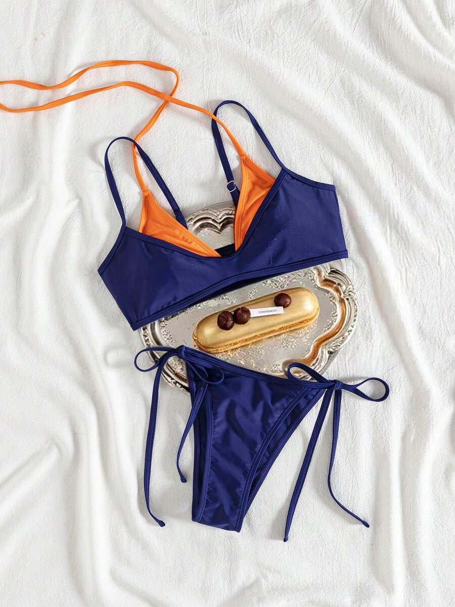 Women's color-block two-piece bikini set featuring a boho geometric pattern, tie-back halter top with removable padding, and matching tie-side bikini bottoms.