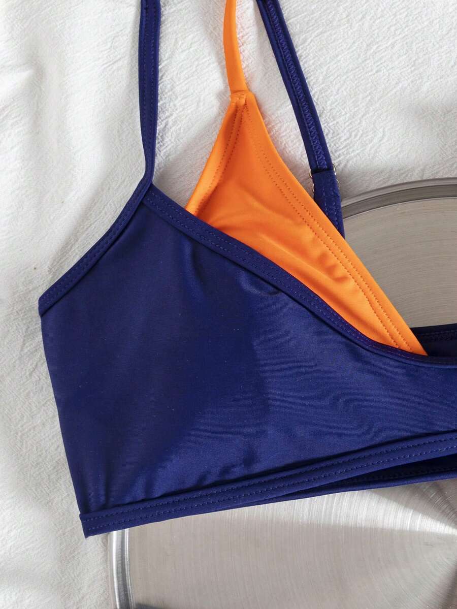 Women's color-block two-piece bikini set featuring a boho geometric pattern, tie-back halter top with removable padding, and matching tie-side bikini bottoms.