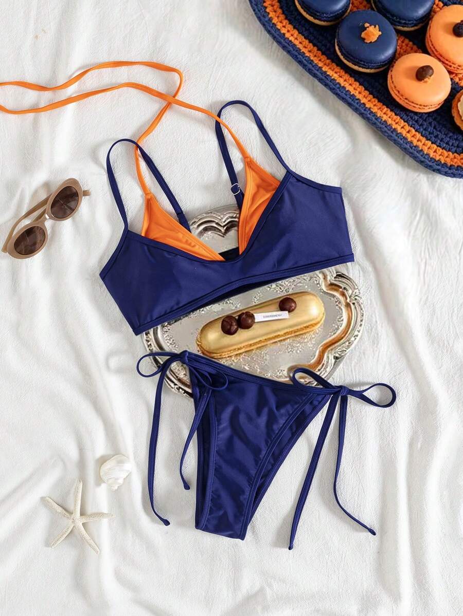 Women's color-block two-piece bikini set featuring a boho geometric pattern, tie-back halter top with removable padding, and matching tie-side bikini bottoms.