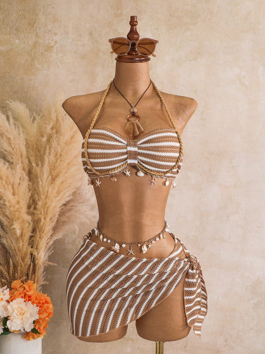 Multicolor striped 3-piece bikini set for women featuring a halter neck top with shell trim and low waist high cut bottoms.