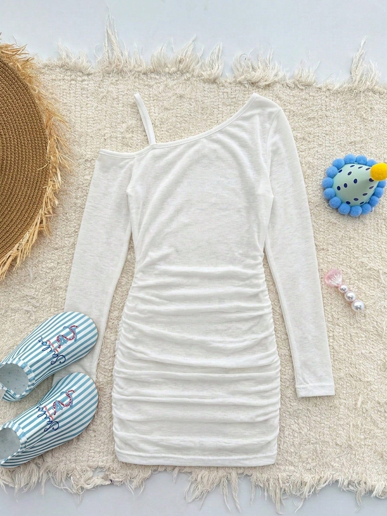 Girls plus size one-piece swimsuit in white with striped pattern, asymmetric neckline, long sleeves, fitted shape, and skirt-style bottom.