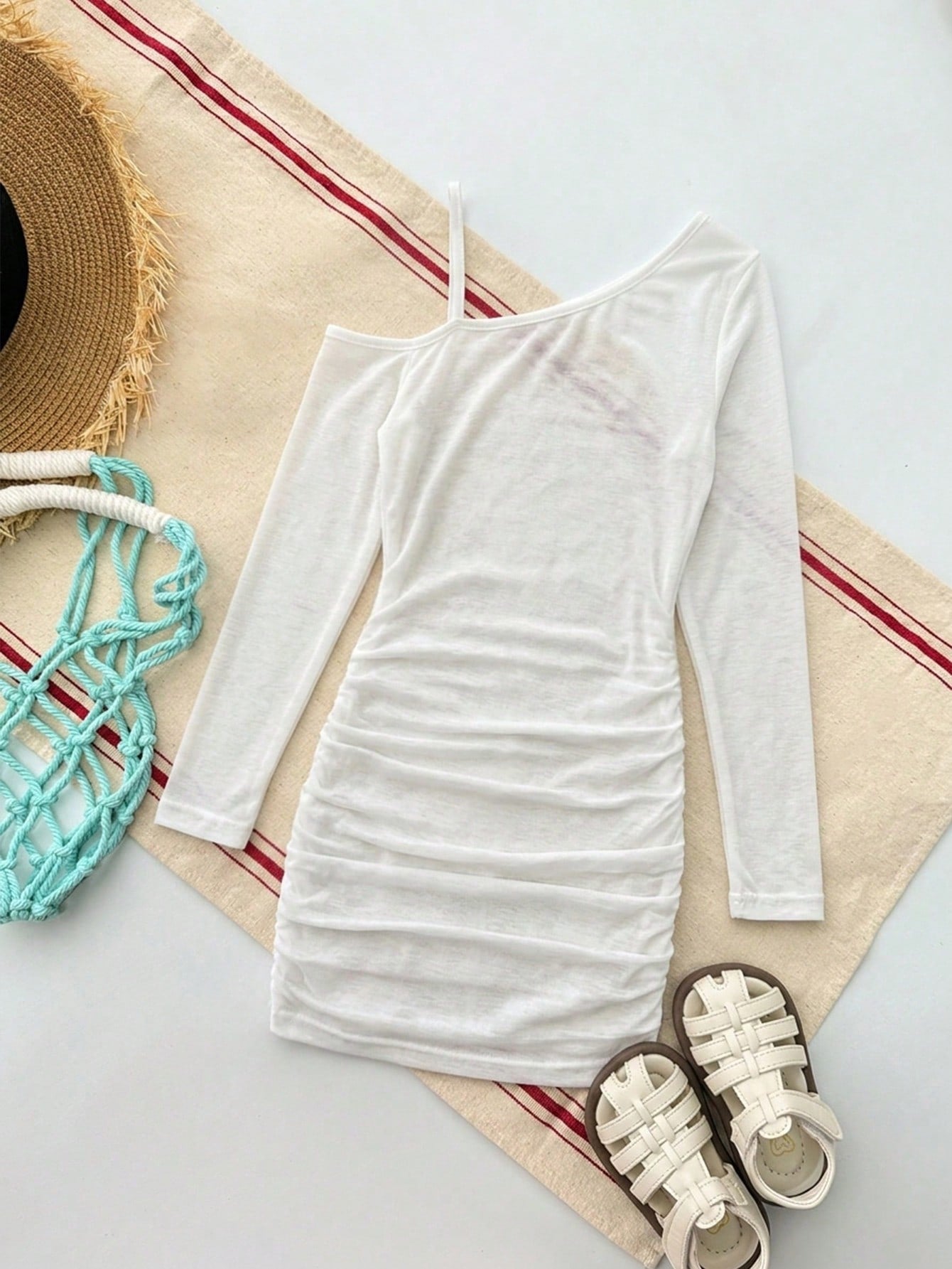 Girls plus size one-piece swimsuit in white with striped pattern, asymmetric neckline, long sleeves, fitted shape, and skirt-style bottom.