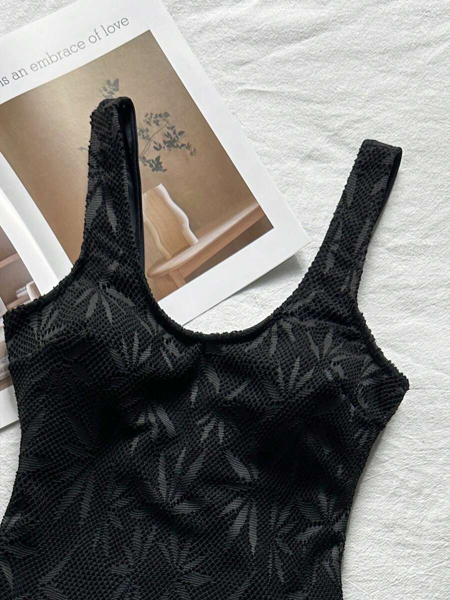 Women's solid color one-piece swimsuit featuring a backless scoop neck design and high cut fit