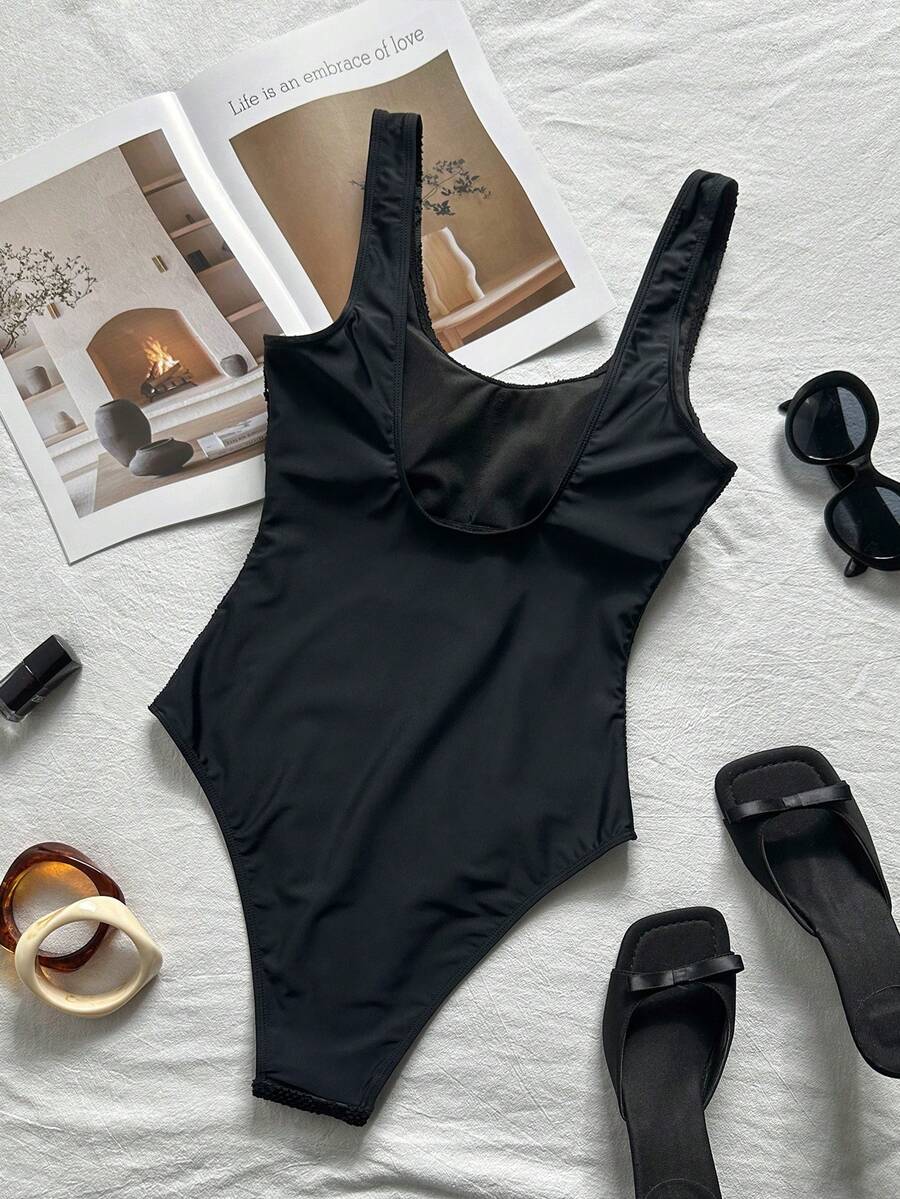 Women's solid color one-piece swimsuit featuring a backless scoop neck design and high cut fit
