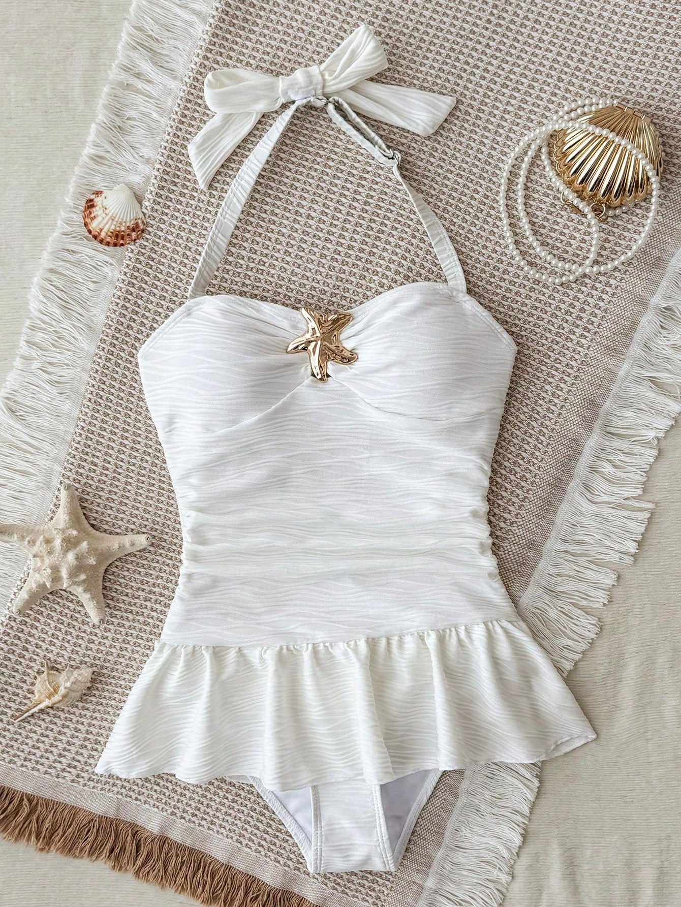 White tween girls one-piece swimsuit with textured fabric, spaghetti straps, tie bow detail, halter style, and open back for summer beachwear.