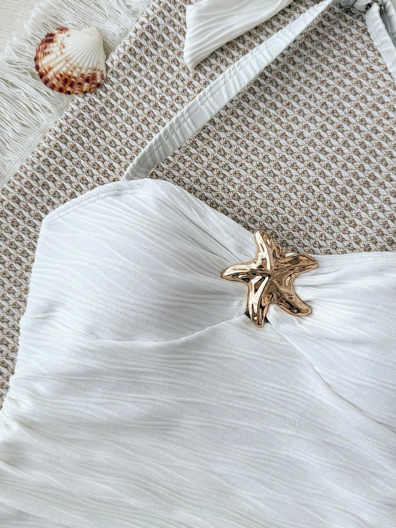 White tween girls one-piece swimsuit with textured fabric, spaghetti straps, tie bow detail, halter style, and open back for summer beachwear.