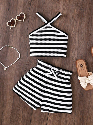 Black and white striped 2-piece set for tween girls featuring a halter sleeveless pullover top with criss-cross knot detail and matching paperbag waist shorts.