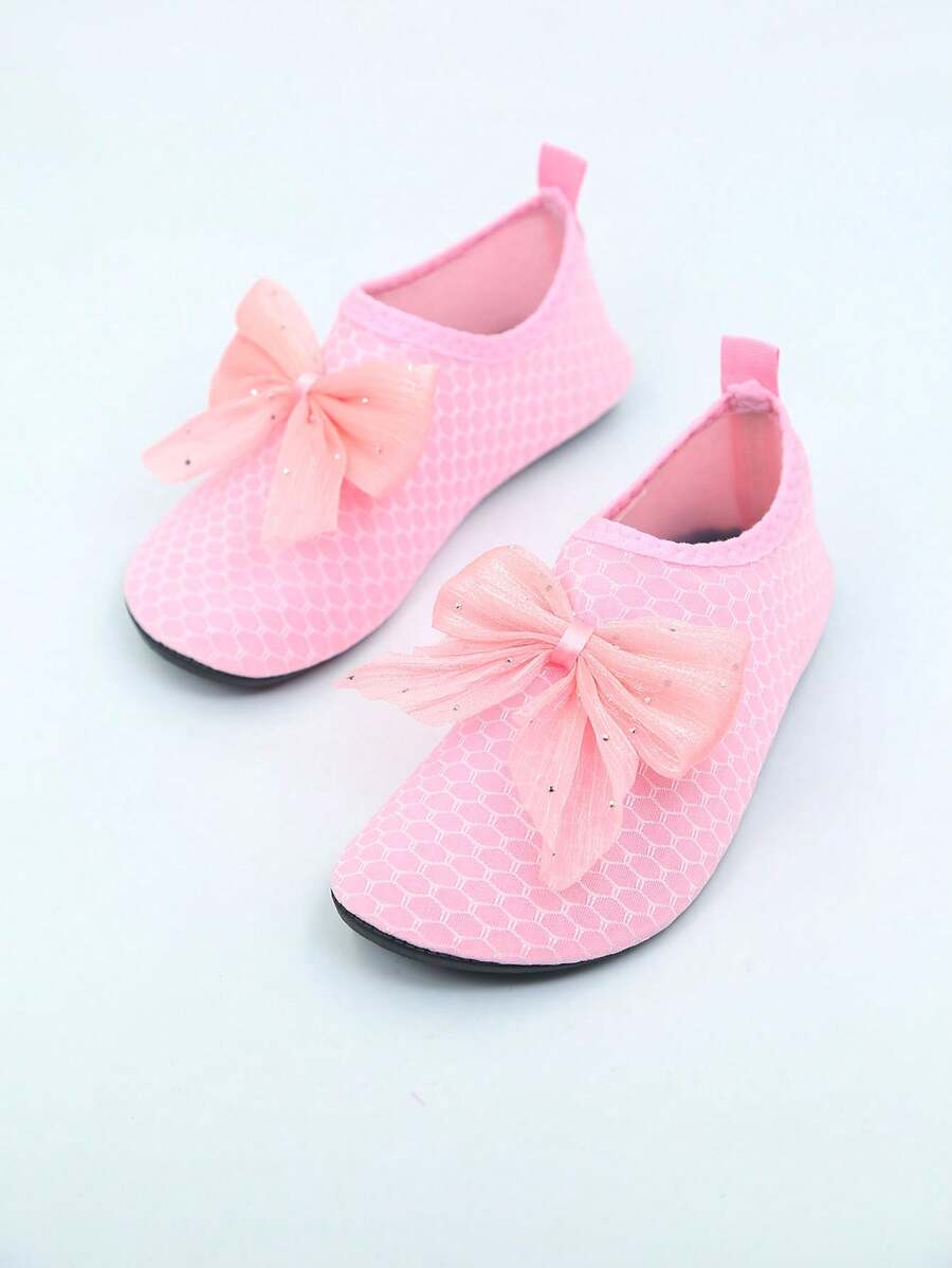 Pair of black kids water shoes with breathable Lycra upper and non-slip rubber sole for boys and girls.