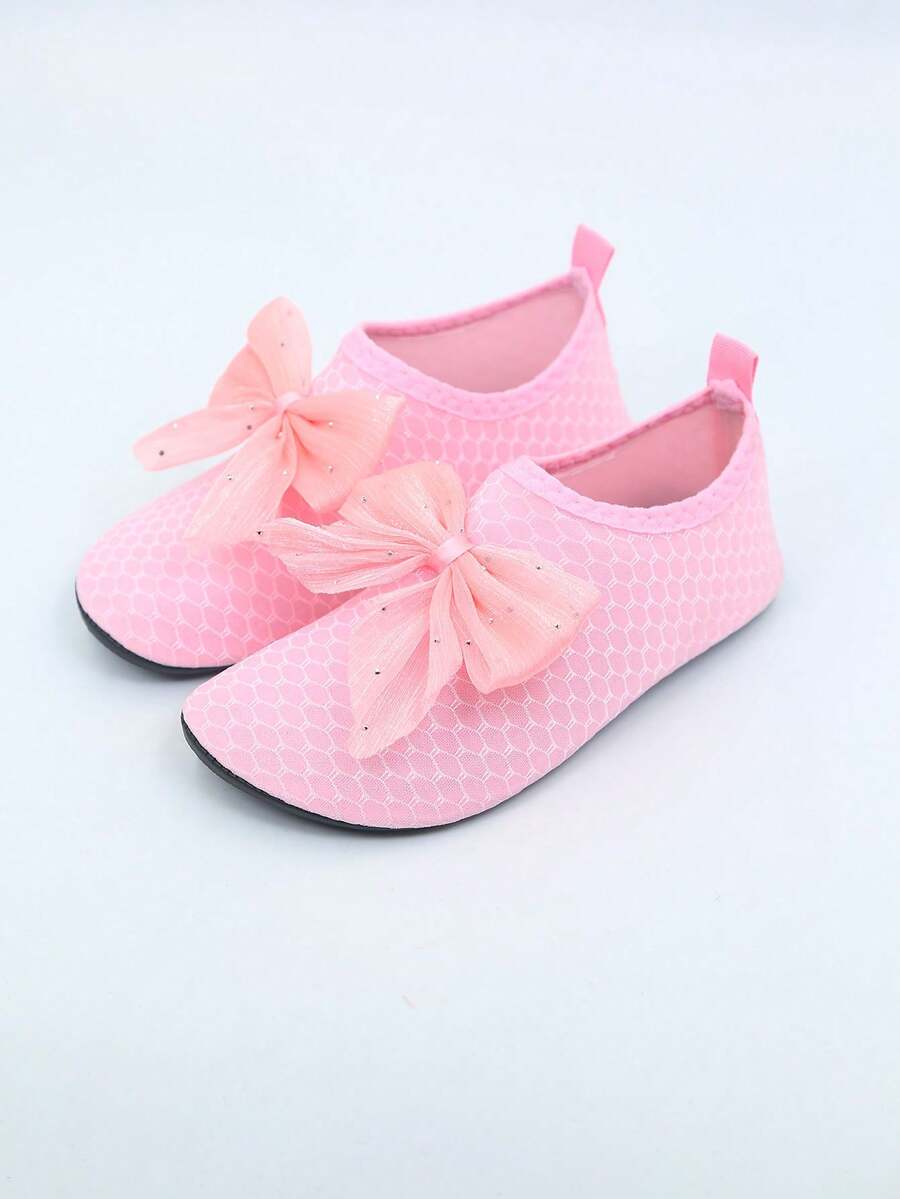 Pair of black kids water shoes with breathable Lycra upper and non-slip rubber sole for boys and girls.