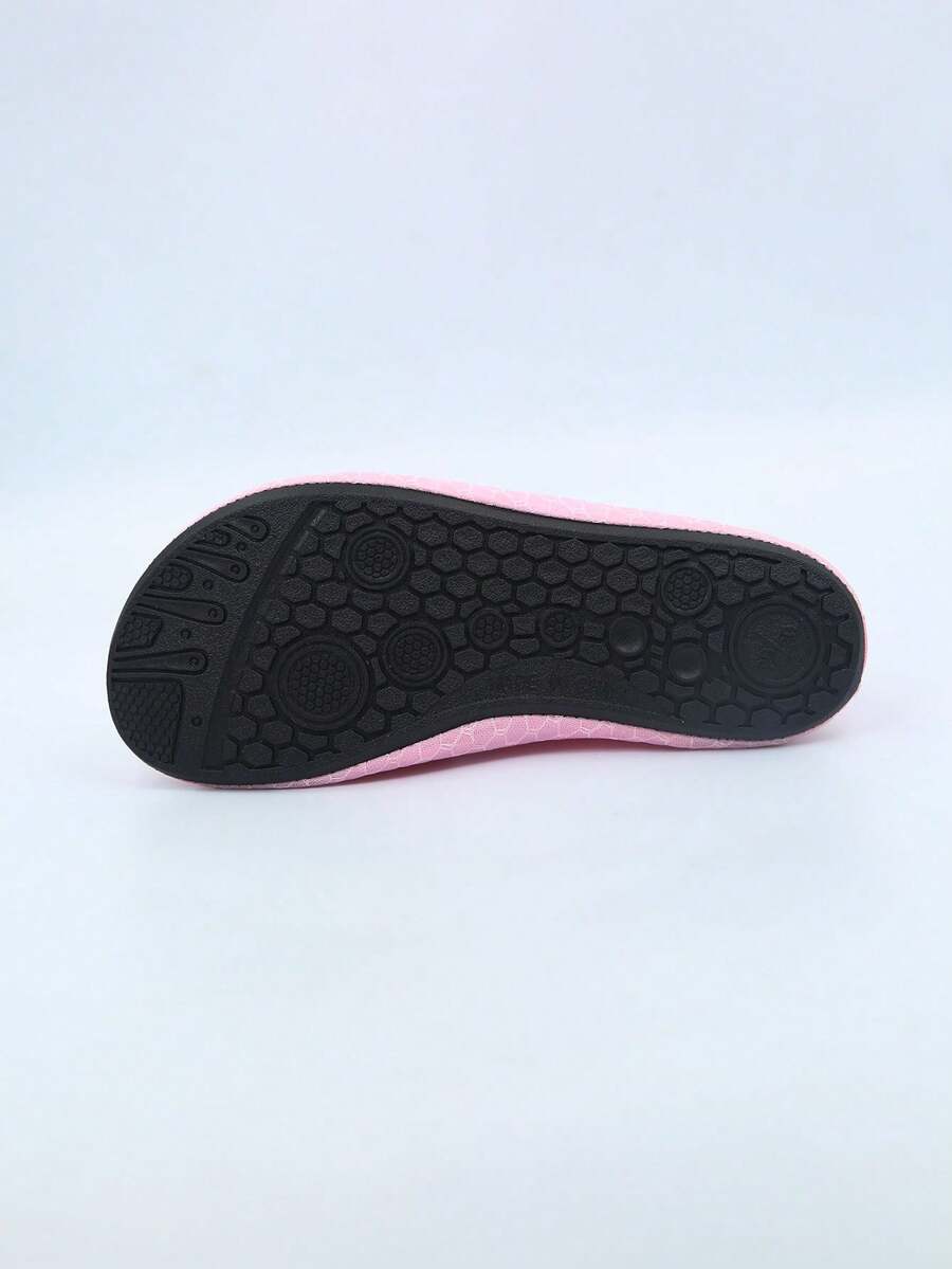 Pair of black kids water shoes with breathable Lycra upper and non-slip rubber sole for boys and girls.