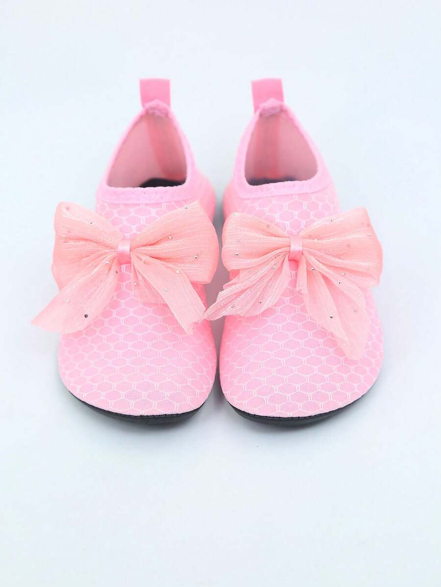 Pair of black kids water shoes with breathable Lycra upper and non-slip rubber sole for boys and girls.