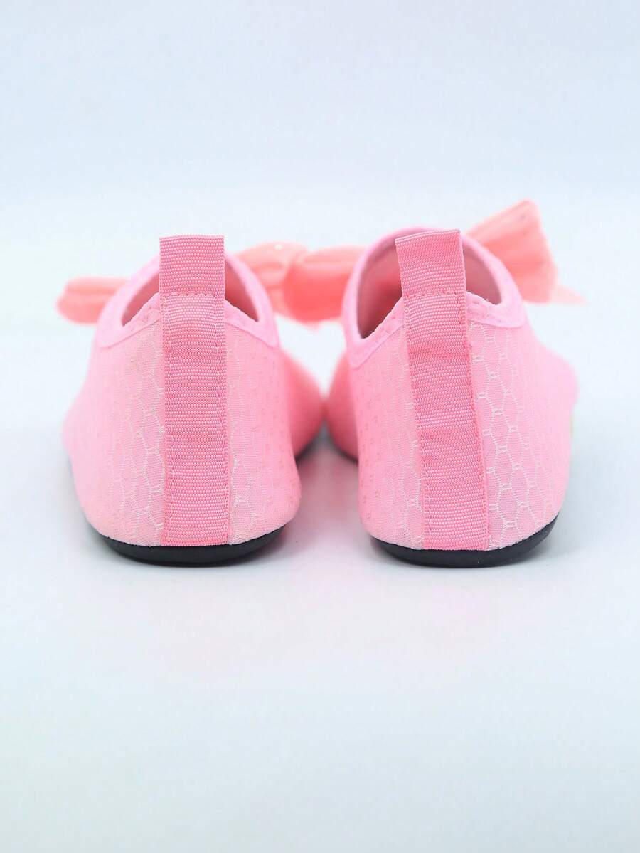 Pair of black kids water shoes with breathable Lycra upper and non-slip rubber sole for boys and girls.