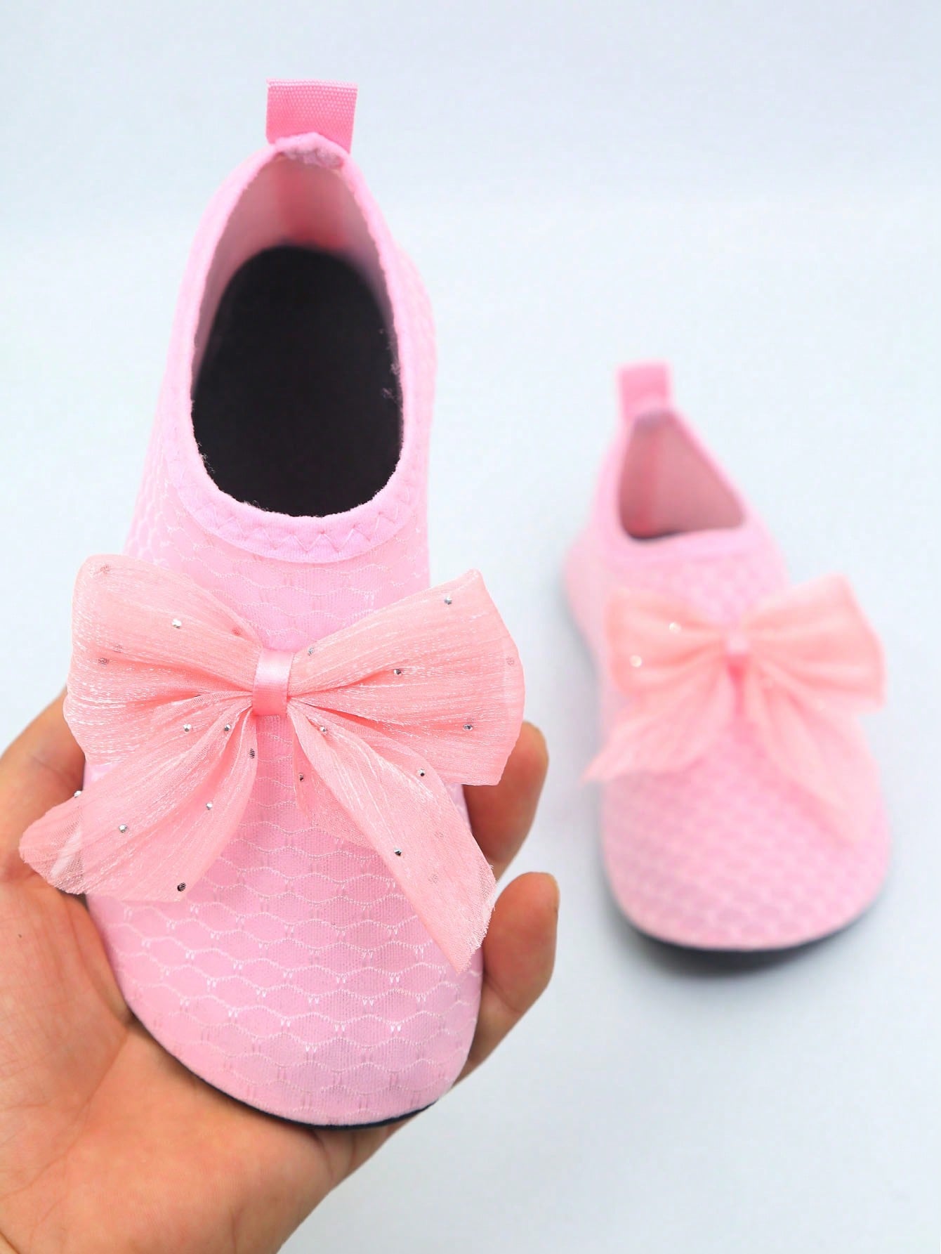 Pair of black kids water shoes with breathable Lycra upper and non-slip rubber sole for boys and girls.