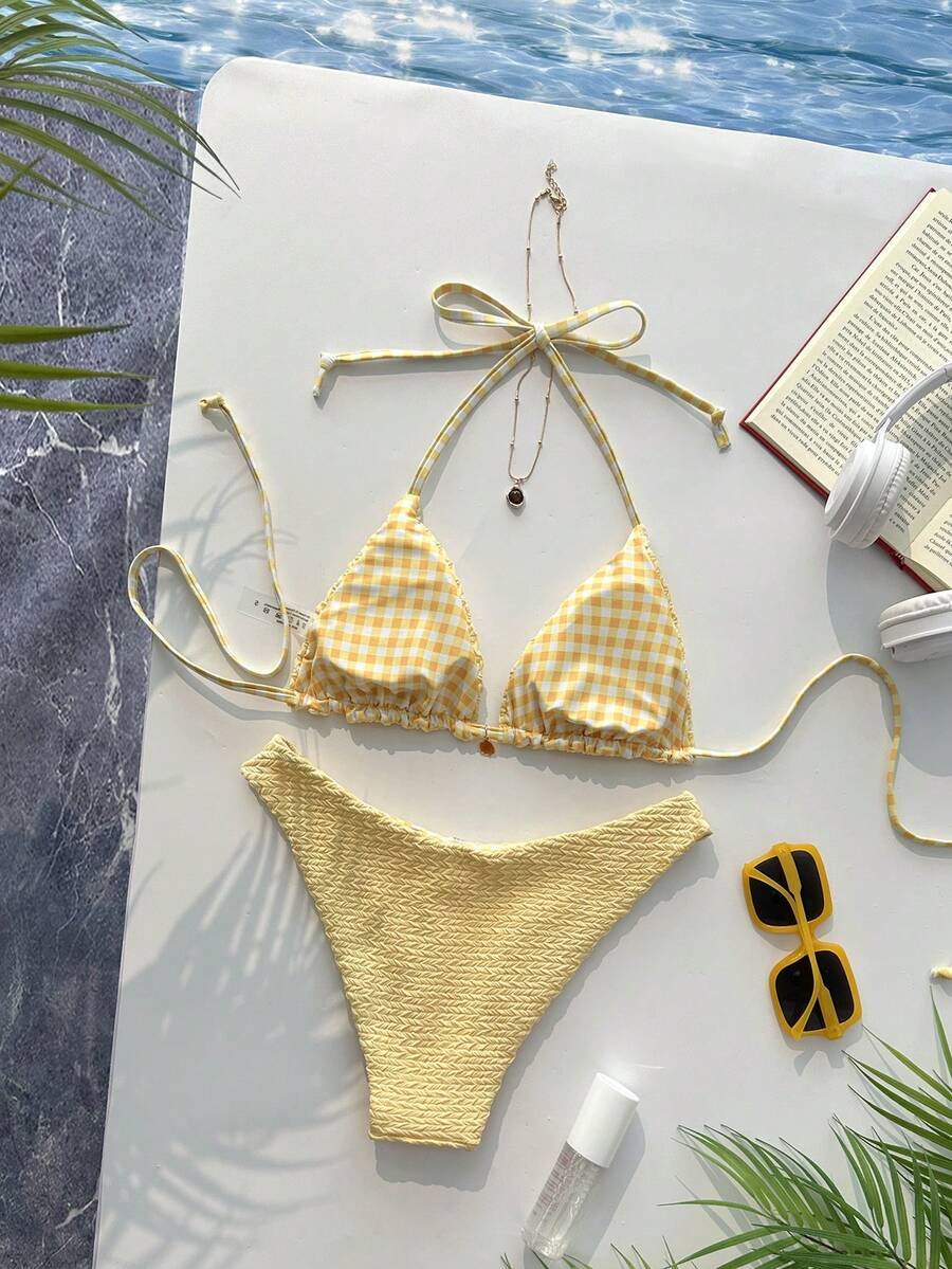 Women's black textured plaid 2-piece bikini set featuring a halter neckline, wireless triangle cups with removable padding, and mid-waist bottoms.