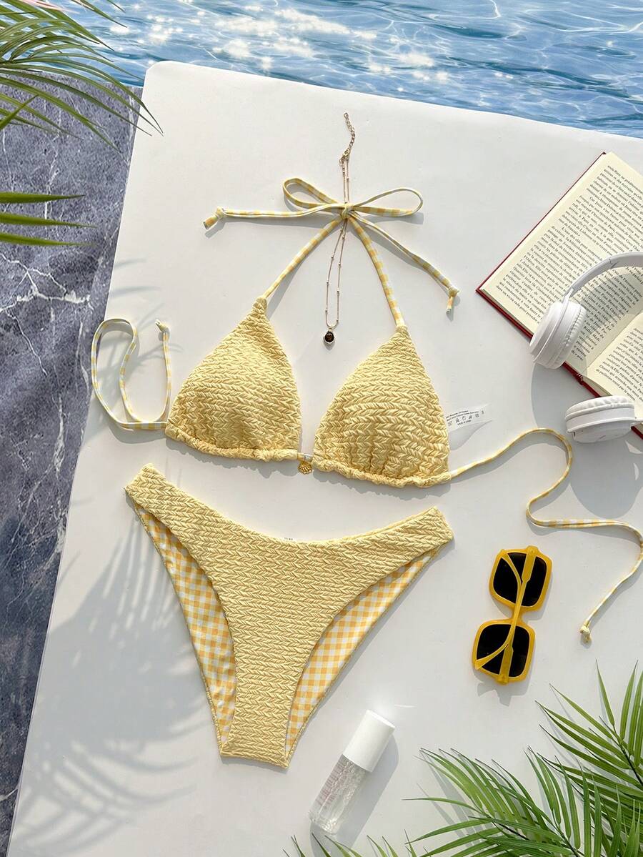 Women's black textured plaid 2-piece bikini set featuring a halter neckline, wireless triangle cups with removable padding, and mid-waist bottoms.