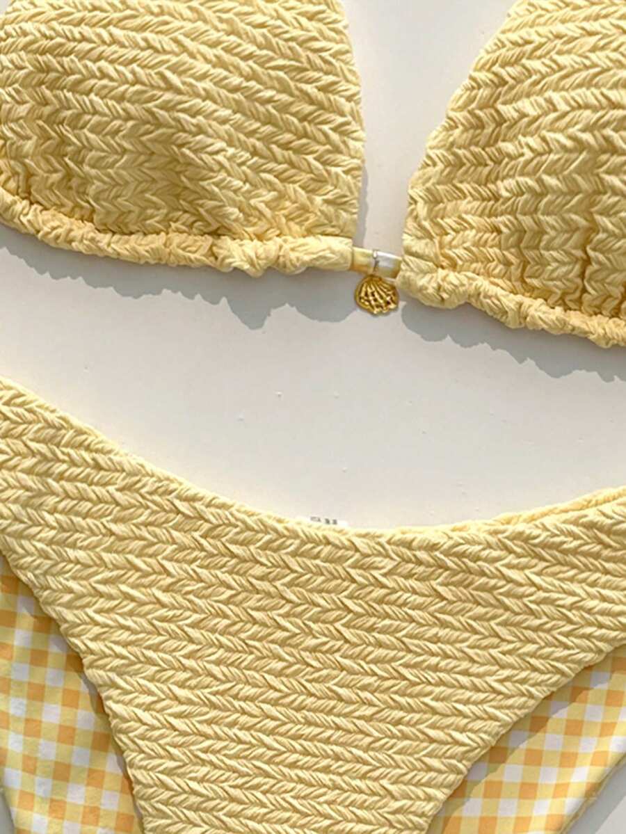 Women's black textured plaid 2-piece bikini set featuring a halter neckline, wireless triangle cups with removable padding, and mid-waist bottoms.