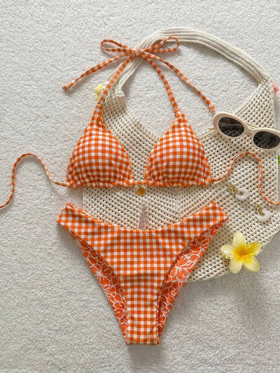 Women's black textured plaid 2-piece bikini set featuring a halter neckline, wireless triangle cups with removable padding, and mid-waist bottoms.